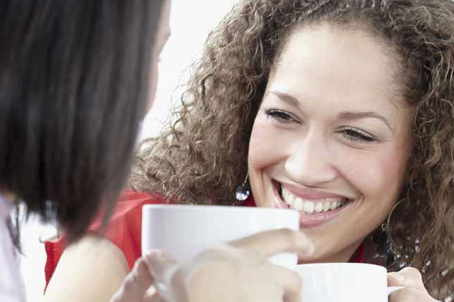 Two customers at a table with coffee