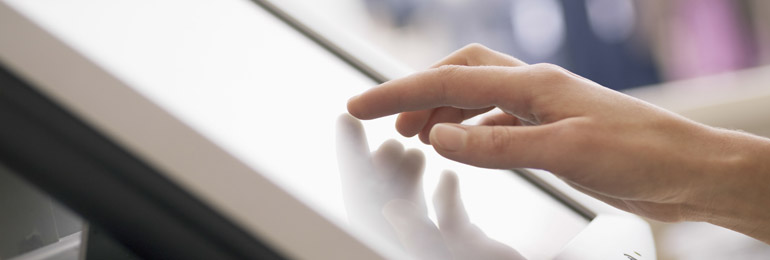 A hand operating a touch screen till