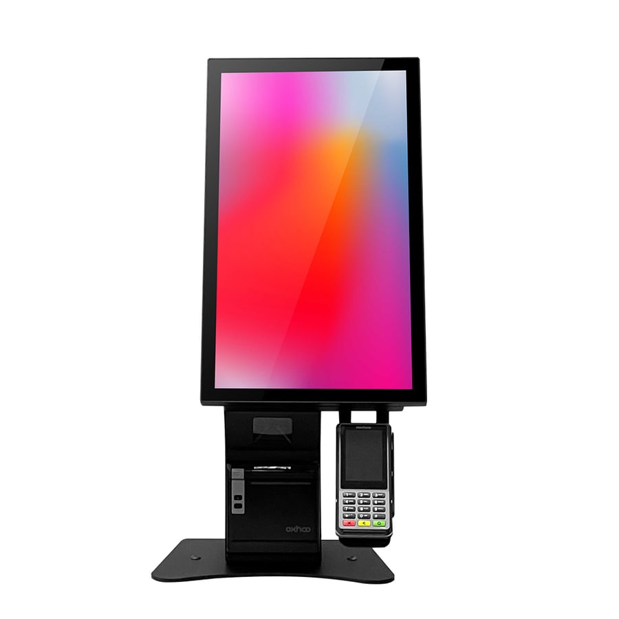 The Oxhoo ELYA 21 self-service kiosk on a countertop base, a portrait touchscreen above a receipt printer and a card terminal in its cradle